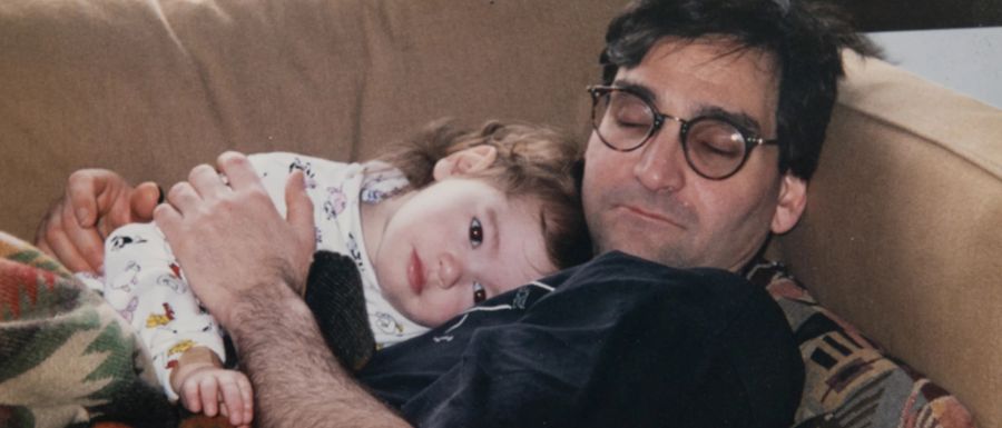 An old family photo of Maia as a baby resting on her father's chest