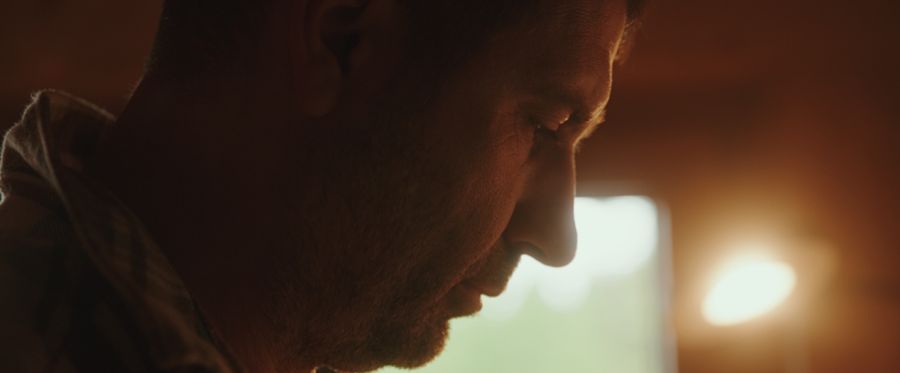 A man in profile, lit from behind